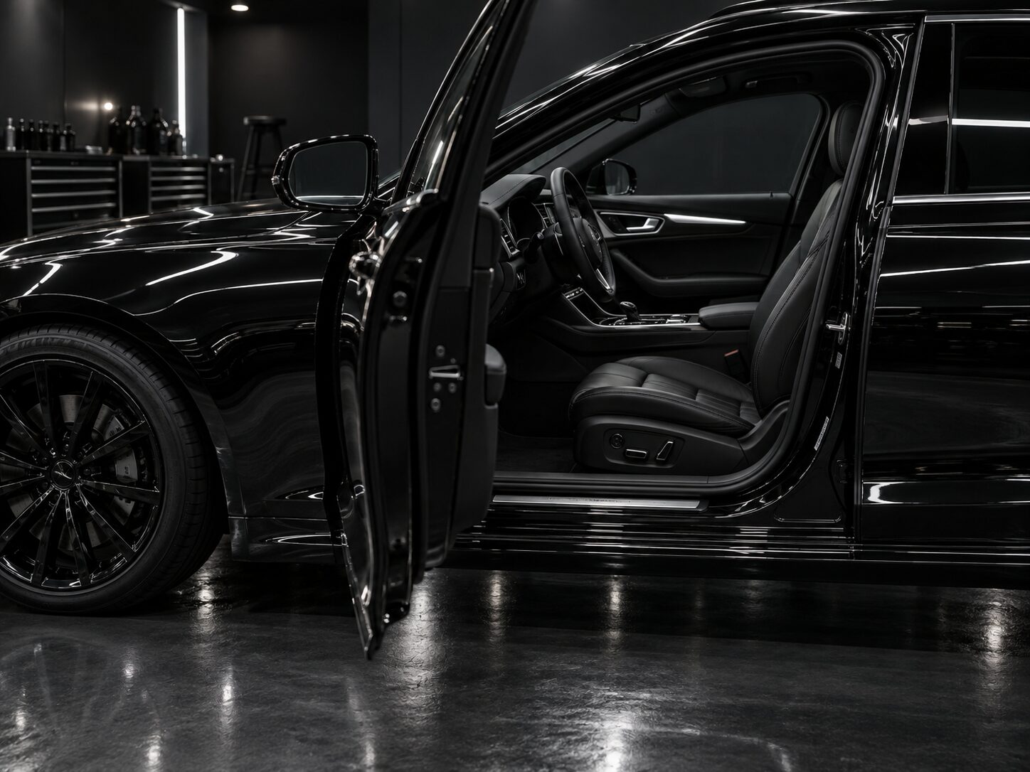 Freshly detailed black sedan with the door open