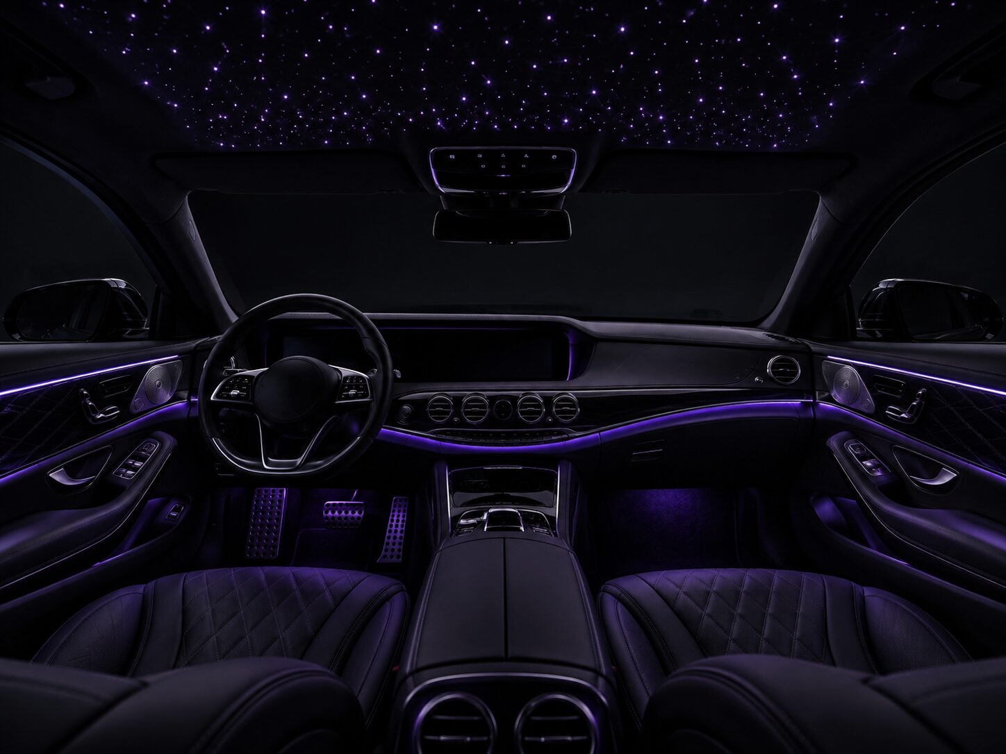 Car interior with violet ambient lighting at night