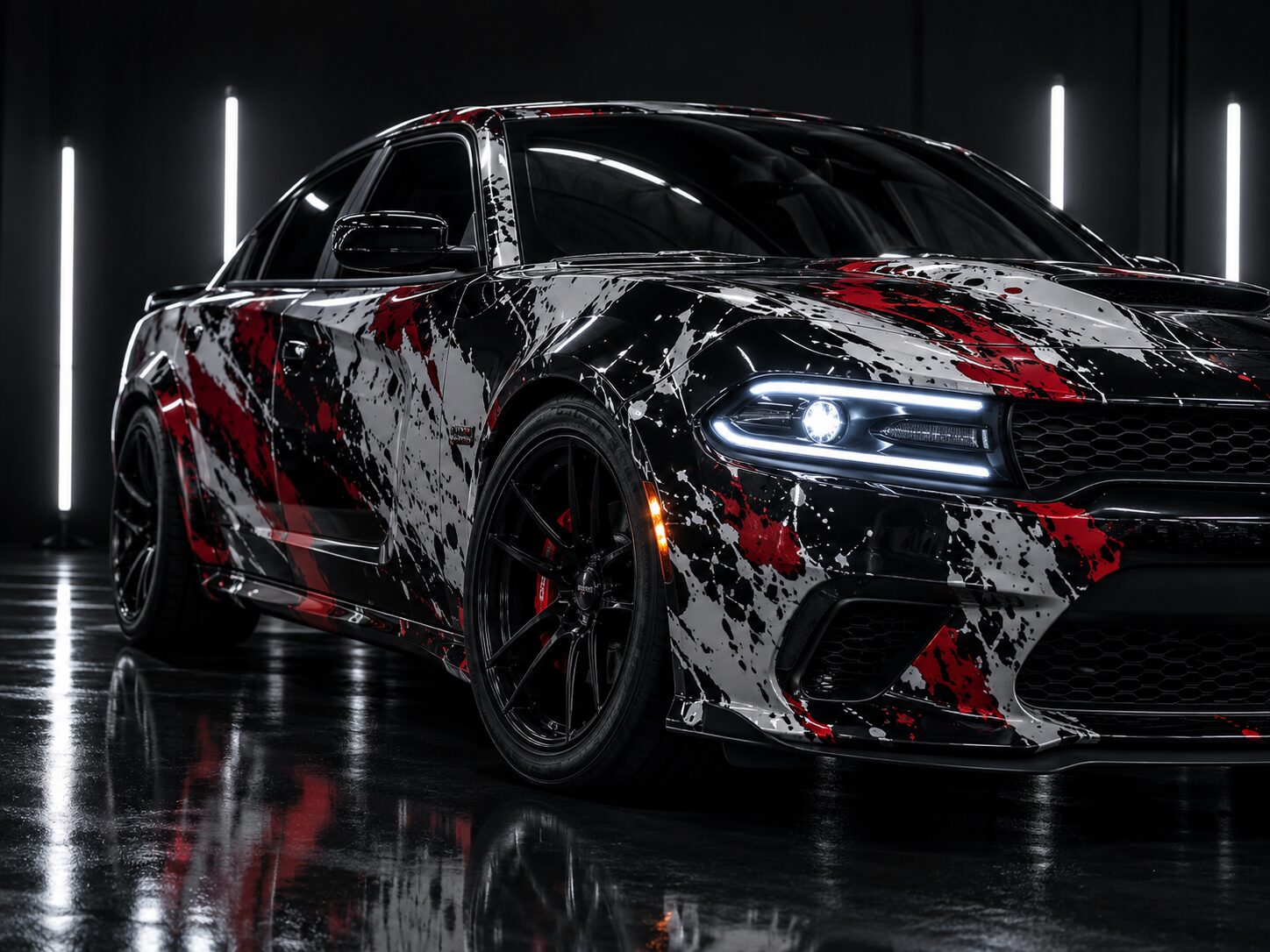 Black sedan with a custom red, white and black splatter wrap